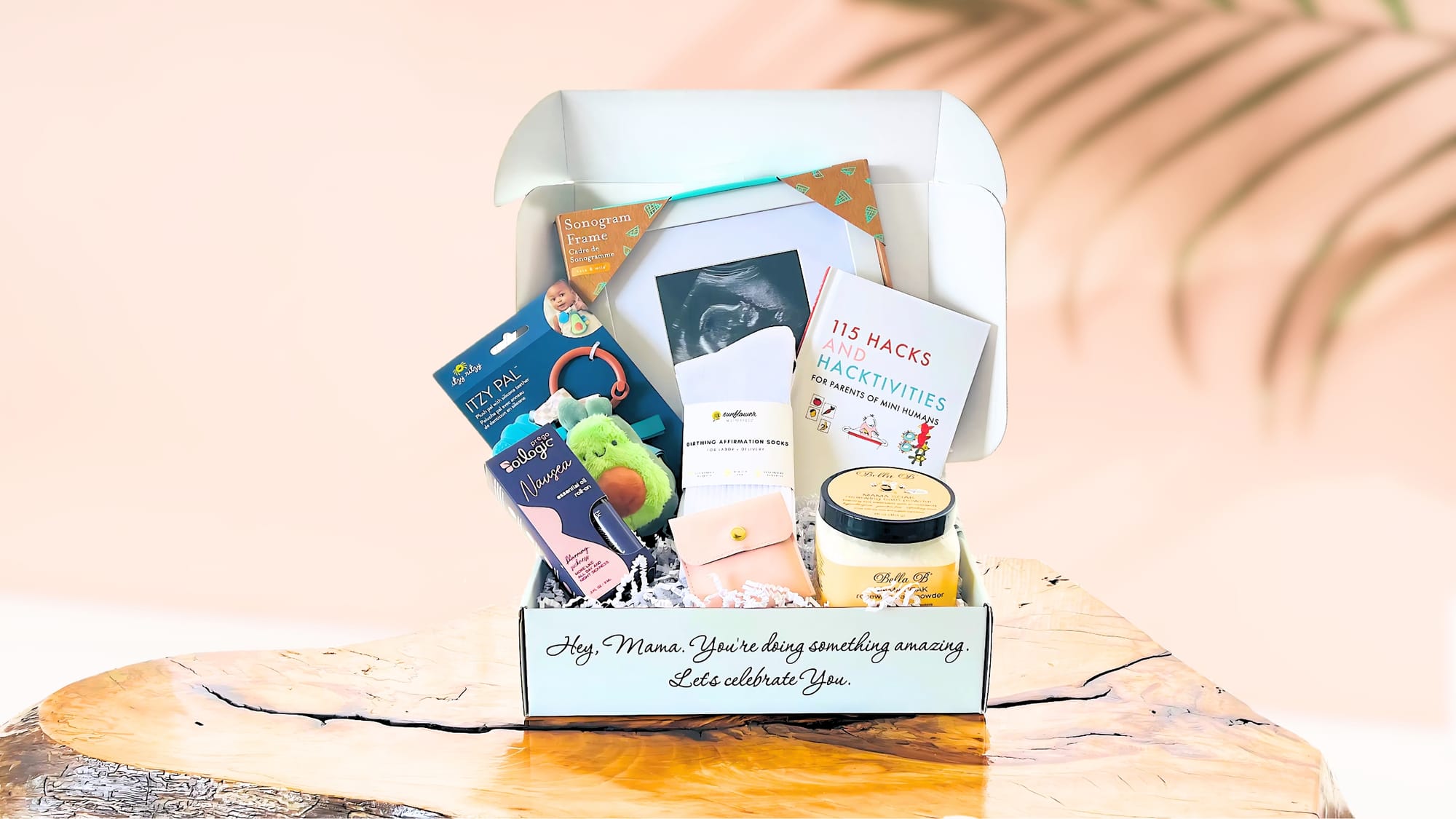An open Charmed Beginnings box of comforts on a table